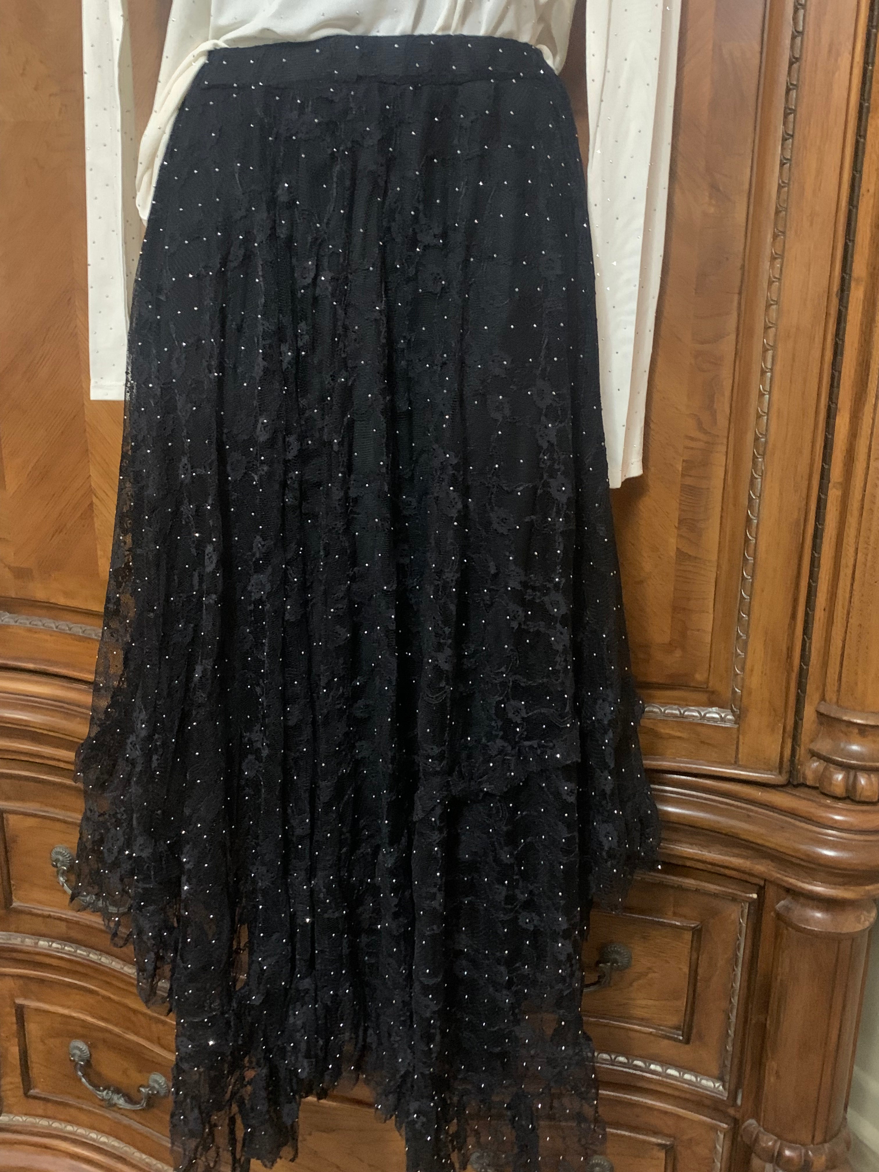 Black lace skirt with white blouse on wooden wardrobe