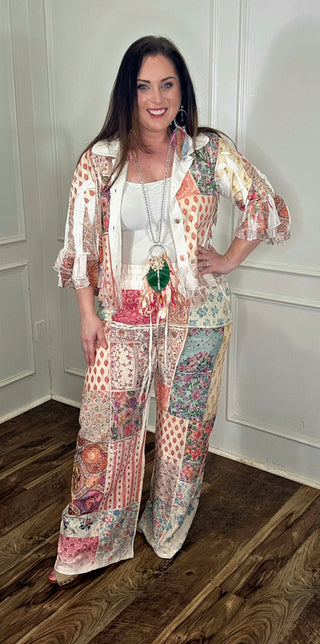 Woman wearing a floral outfit with a white wall background