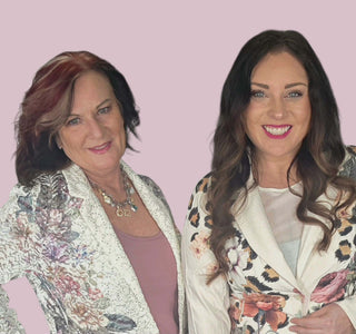 Two women wearing floral and leopard print cardigans against a pink background